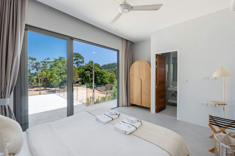 Slide open the glass doors and step onto your private balcony where you can gaze across green hills and feel the island breeze.