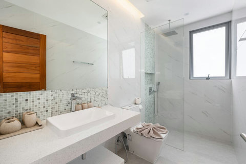 Luxe bathroom time awaits with crisp marble surfaces, a generous vanity, and a rainfall showerhead that makes every shower feel like a spa retreat.