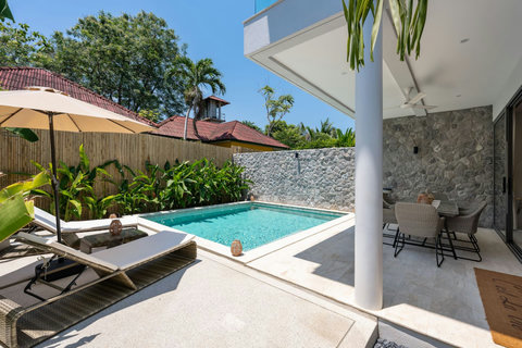 Your private oasis awaits, with crystal-clear water, leafy tropical backdrop, and shaded spots to retreat throughout the day.