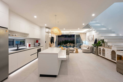 Step through the entrance and feel the warmth of home—the open living spaces glow invitingly as evening falls, ready for you to unwind and relax.