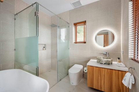 Modern ensuite bathroom with rain shower and designer vanity