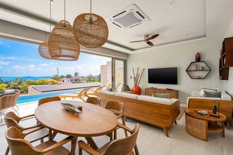 Bright living and dining area with sea view and smart TV