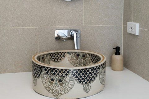 Designer bathroom basin with artisanal metalwork detail