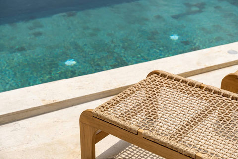 Pool edge detail with rattan tray for poolside refreshments