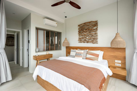 Master bedroom with rattan accents and natural light