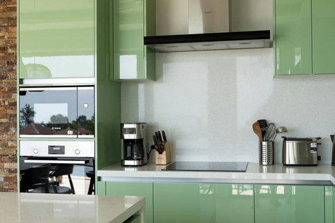 Kitchen detail with built-in oven, coffee machine and premium appliances