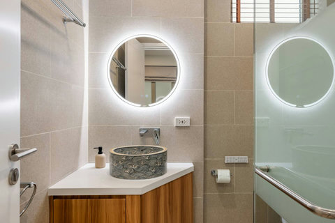 Bathroom with circular metalwork basin and bathtub