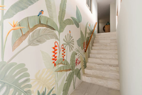 Tropical mural staircase leading to bedroom level