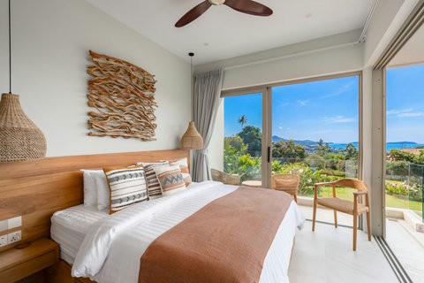 Bedroom seaview from another angle showcasing tropical surroundings