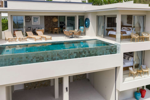 Two-level villa with pool deck above and bedroom terrace below