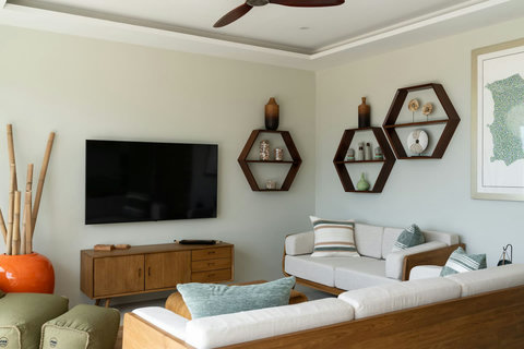 Living area with smart TV and contemporary hexagonal shelving