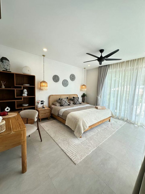 Bedroom with statement shelving and warm lighting at Villa Amala 3BR pool villa Koh Samui.