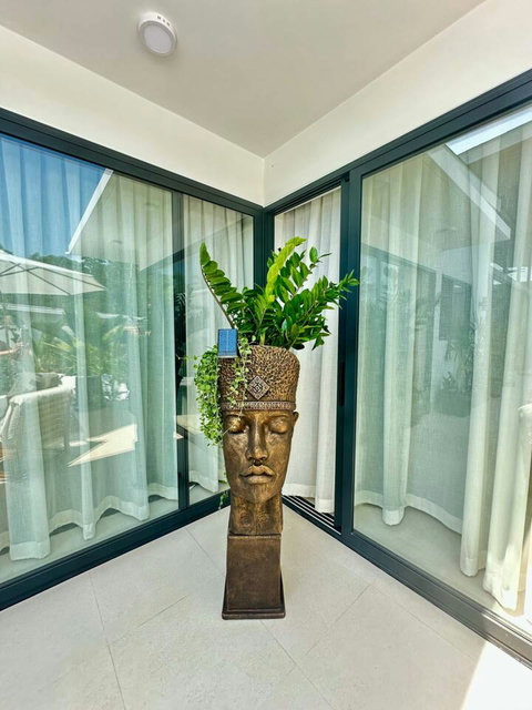 Buddha planter detail at Villa Amala adds Balinese serenity to your Koh Samui pool villa.