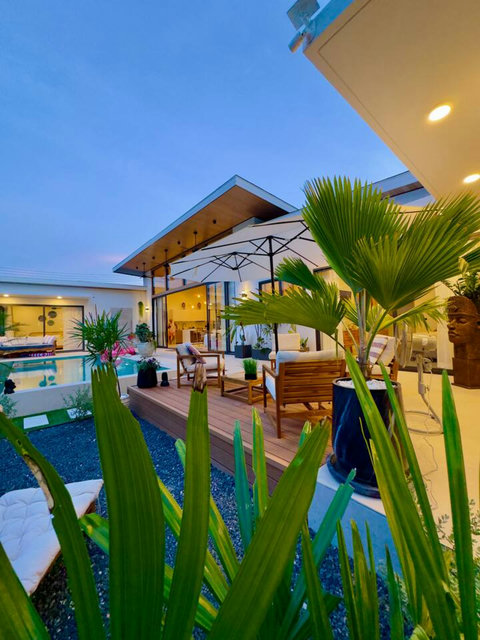 Covered outdoor terrace with lounge and umbrella – relax poolside at Villa Amala 3BR pool villa Koh Samui.