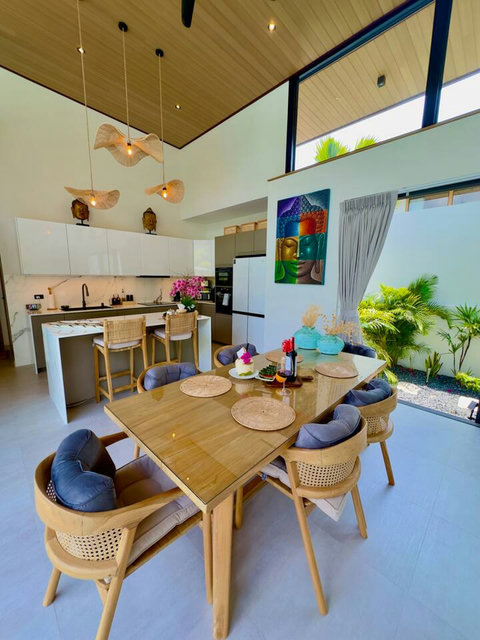 Kitchen island and dining area with tropical garden views at Villa Amala 3BR pool villa Koh Samui.