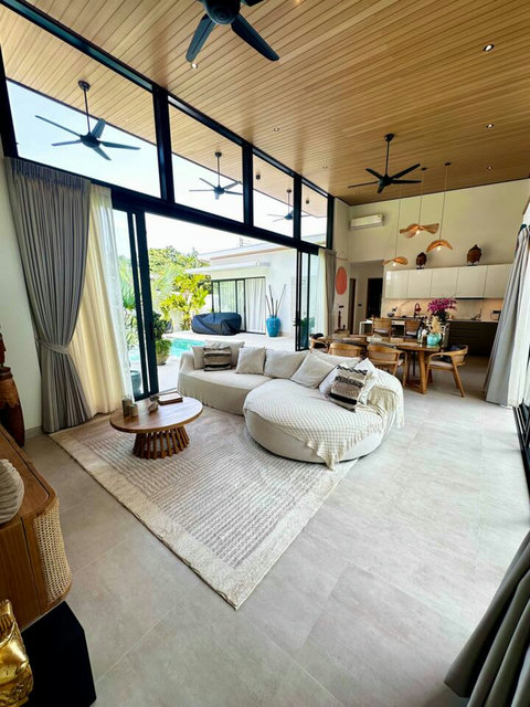 Bright open-plan living and dining at Villa Amala – curved sofa, designer décor inside this 3 bedroom Koh Samui pool villa.