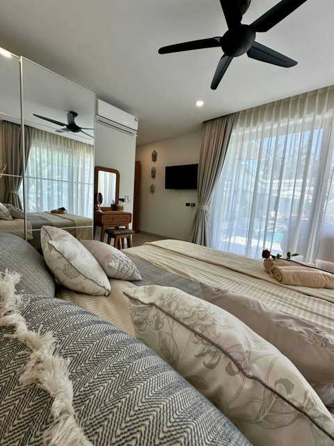 Comfortable bedroom with TV and natural light at Villa Amala 3BR pool villa Koh Samui.