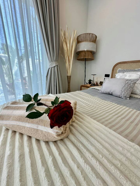 Romantic bedroom turn-down with rose at Villa Amala 3BR pool villa Koh Samui.