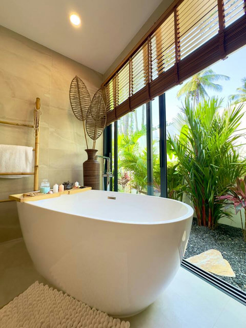 Freestanding bathtub framed by tropical greenery – Villa Amala 3BR pool villa Koh Samui.