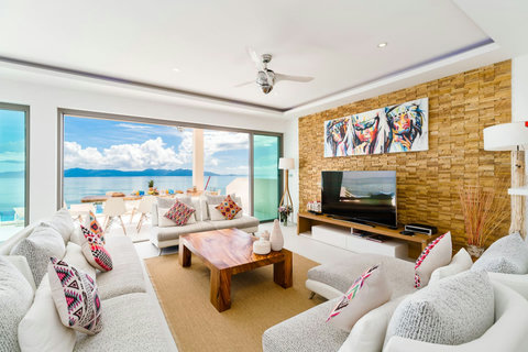 A beautifully designed, bright living room seamlessly combining cozy interior style with a breathtaking view of the sea