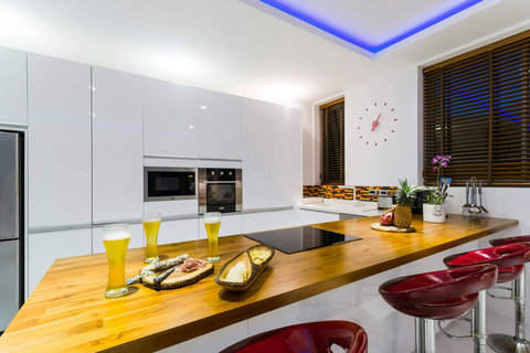 A fully equipped gourmet kitchen featuring premium modern appliances, sleek cabinetry, and a clean minimalist aesthetic