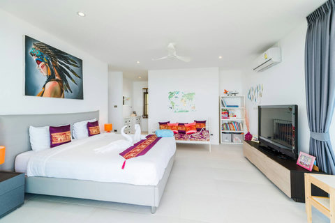 Elegant and spacious bedroom featuring a charming reading corner and library setup, designed for ultimate relaxation