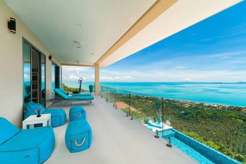 Balcony Bedrooms N°1/2 An expansive private balcony terrace featuring comfortable sun loungers and a stunning, uninterrupted view of the blue ocean