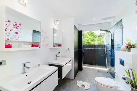 Sleek and modern ensuite bathroom featuring clean minimalist design, premium fixtures, and plenty of natural light