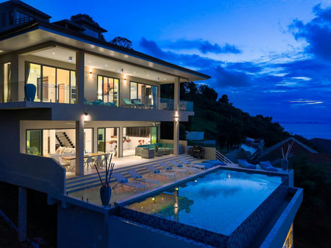 Night View Showcasing the multi-level architectural luxury of the villa under night skies, highlighted by premium exterior lighting