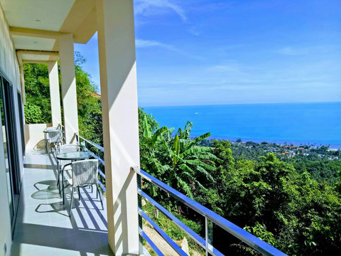 Step out to paradise: Private bedroom balcony offering a refreshing breeze and views of the lush greenery and ocean.