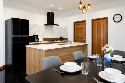 Fully equipped kitchen and dining space where you can cook family meals or prepare beach-day picnics.