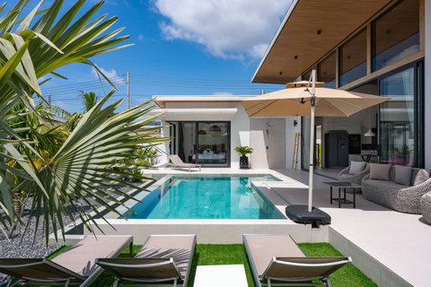 Poolside loungers and a shaded outdoor seating area