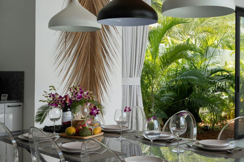 Dining table with pendant lighting and tropical garden views