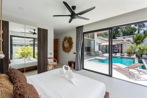 Pool-view bedroom with sliding glass doors onto the terrace