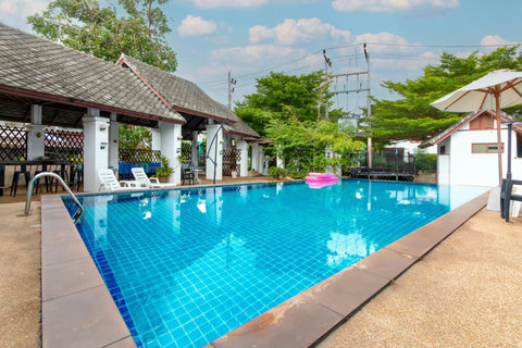 Relax poolside in this tropical oasis with plenty of lounge space.