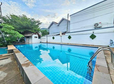 Cool off in the sparkling communal pool surrounded by lush gardens—a refreshing place to relax between island adventures.