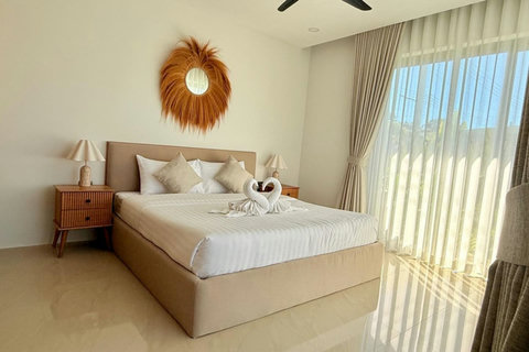 Bright and comfortable bedroom with garden views at a private Koh Samui villa