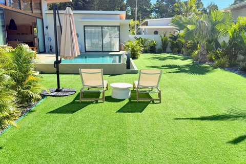 Spacious tropical garden with sun loungers at a Koh Samui holiday villa