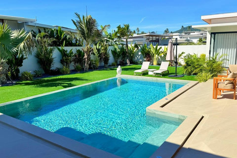 Private swimming pool surrounded by lush greenery at a luxury Koh Samui villa