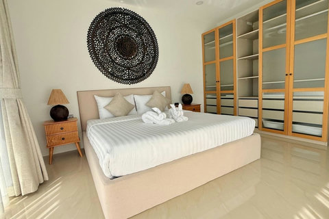 Modern king bedroom with natural wooden furnishings at Villa Jo