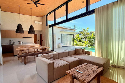Open-plan kitchen and living area overlooking the tropical garden and private pool