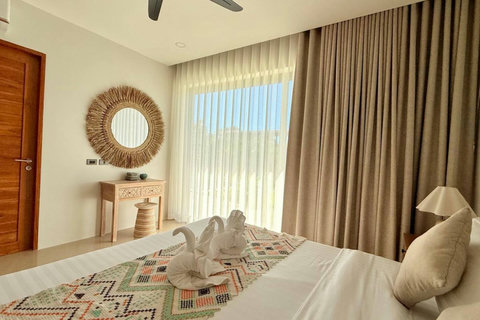 Bright tropical bedroom with garden views in a private Koh Samui villa
