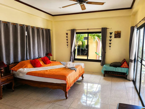 Guests rest undisturbed in this airy second bedroom, cool and quiet for a sound sleep.