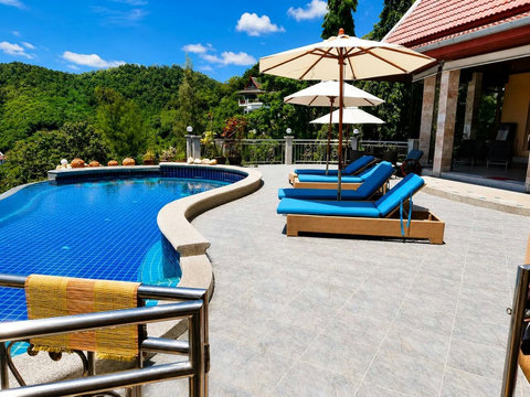 Lounge poolside as the warm sun dries you after a swim, with nothing but gardens and sky around you.