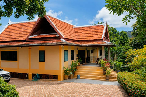 Discover the villa's striking modern design nestled into the hillside, where every angle captures the landscape.