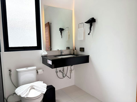 Stylish bathroom vanity with natural light, quality fittings, and fresh guest towels.