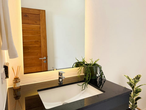 Warm modern bedroom entrance with natural wood details and elegant tropical styling.