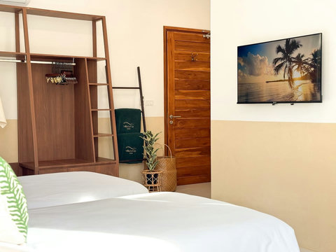Modern bedroom entrance with warm wooden finishes, wardrobe space, and villa amenities.