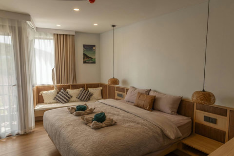 Queen bed nook with rattan pendant lighting and a built-in daybed corner