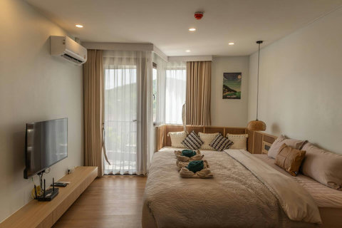 Sheer curtains soften the light in this relaxing Bo Phut condo bedroom